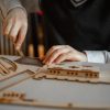 a-boy-in-school-uniform-makes-a-3d wooden puzzles 2023-11-27-05-10-19-utc