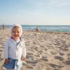 baby on beach by sea in summer featured in article for the best summer gear for babies in 2024