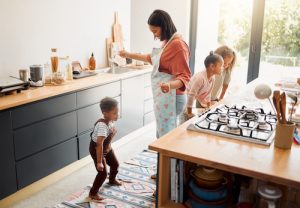 image shows family in a kitchen and is featured in an article Family Kitchen Safety Made Simple: Expert Tips and Essential Gadgets for 2025